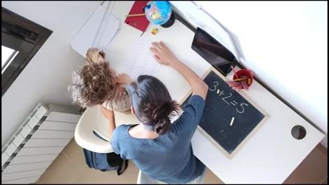 Mother helping her son do homework back to school. Video stock 270484219