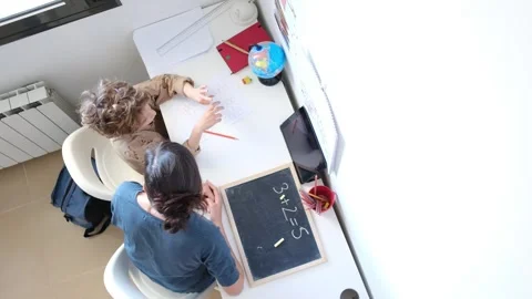 Mother helping her son do homework back to school. Video stock 270484223