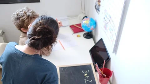 Mother helping her son do homework back to school. Video stock 270484238