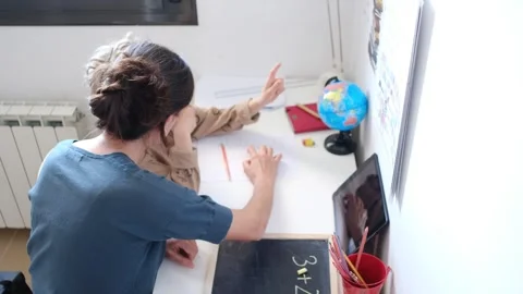 Mother helping her son do homework back to school. Video stock 270484247