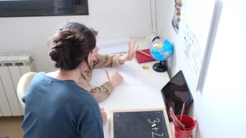 Mother helping her son do homework back to school. Stock Footage 270484252