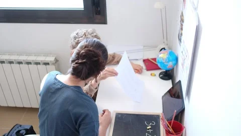 Mother helping her son do homework back to school. Stock Footage 270484272