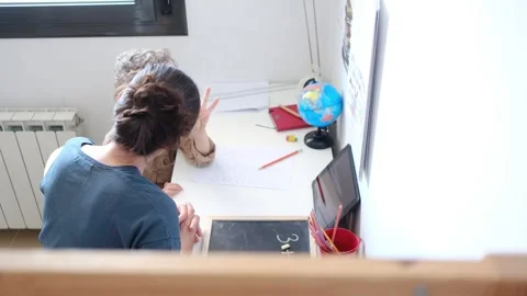 Mother helping her son do homework back to school. Stock Footage 270484277
