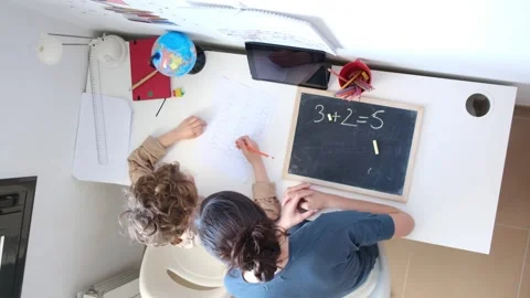 Mother helping her son do homework back to schoo Stock Footage 270484284