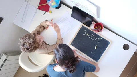 Mother helping her son do homework back to schoo Stock Footage 270484298