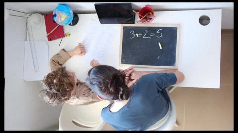 Mother helping her son do homework back to schoo Stock Footage 270484306