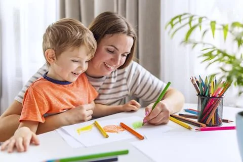 Mother Helps Child with Artwork Using Colored Pencils Stock Photos
