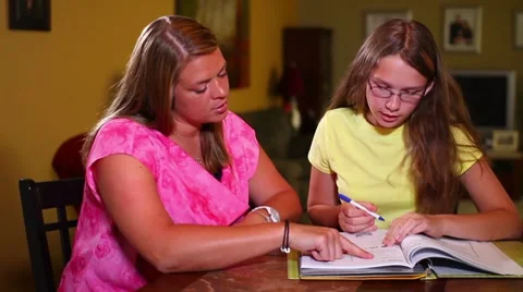 Mother Helps Daughter with Homework Stock Footage