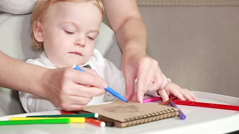 Mother helps to draw Stock-Footage 138582026