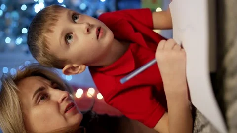 A mother helps her son write a letter to Santa. Stock Footage 258359437