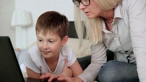 Mother helps son do homework on laptop. Online learning. Education on isolation. Stock Footage 140920707