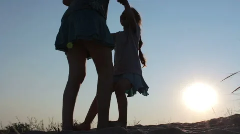 Mother with her child having fun on the beach at sunset time 動画素材 52436331