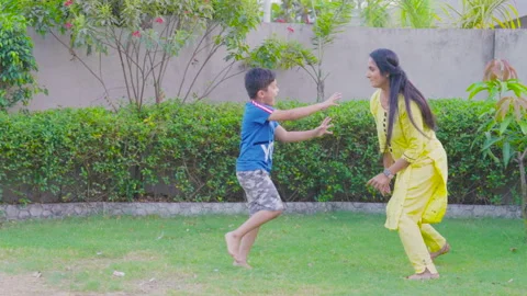 Mother with her cute son playing together throwing grasses on each other Stock Footage 220722884
