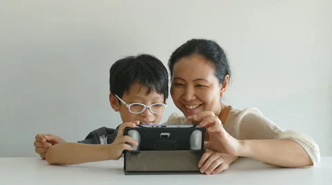 Mother with her son web surfing on digital tablet Stock Footage 56604513