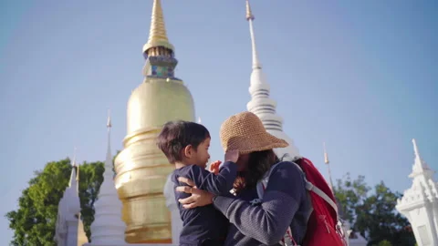 Mother hold boy while walking travel in buddha temple golden pagoda background Stock Footage 145199662