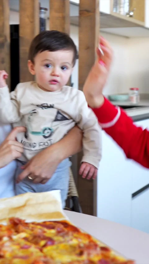 Mother holding baby while preparing lunch in kitchen Stock Footage 302444517