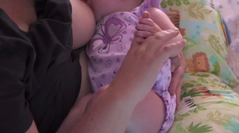 Mother Holding Baby's Hand While Breastfeeding Video stock 40195002