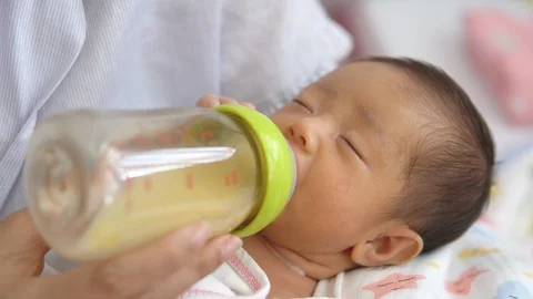 Mother holding newborn baby and feeding Stock Video Pond5