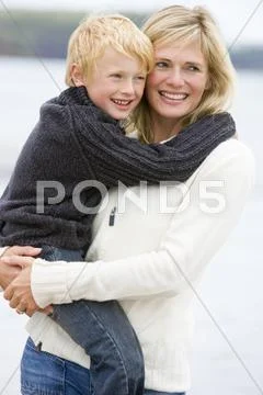 Mother holding son at beach smiling Stock-Fotos