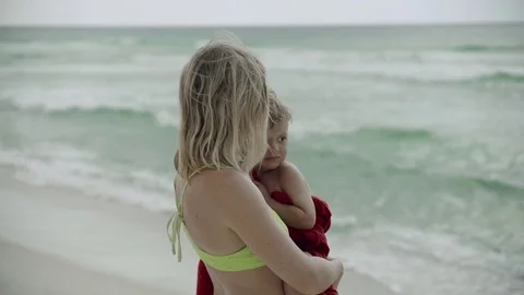Mother holding son on her hand on the shore of the beach. Smiling woman pick up Stock Footage 81497782