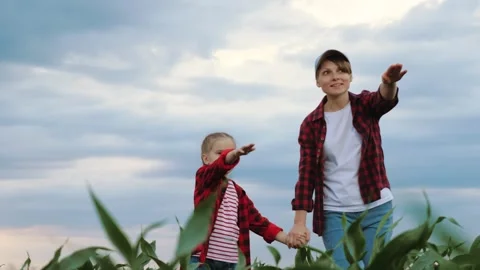 Mother holds hands with future farmer kid engaged in discussion among the Stock Footage 262581479