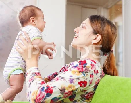 Mother holds little baby Stock Photos