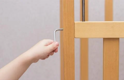 Mother installs and assembles a cot for a child, close-up, copy space Foto stock