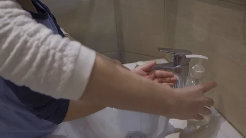 Mother instructs her son how to wash careful his hands. Stock Footage 130044331