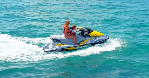 Mother on Jet Ski with Young Son, Tropic... | Stock Video | Pond5