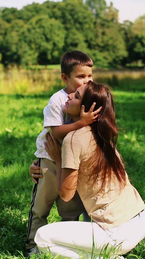 Mother with kid having fun in public green park. Happy mom laughing together Stock Footage 321897699
