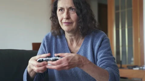 Mother learning to play video games Stock Footage 188940339