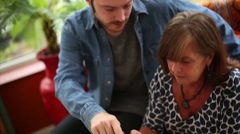 Mother Learns How to Use Tablet by Son Video stock 53472456