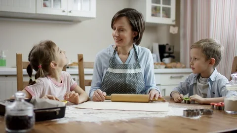 Mother let children start do differ kind of cookies they whant to cook Stock Footage 108173652