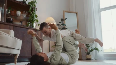 Mother lifting son in airplane pose playful lifestyle family happiness Stock Footage 317552753