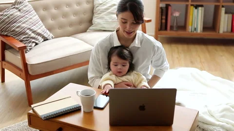 Mother looking at children while working Stock Footage 161941269