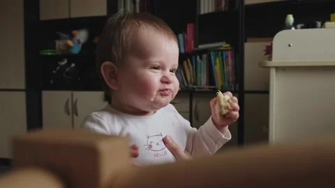 The mother makes the child smile while he eats a piece of banana. Healthy Stock Footage 170676943
