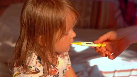 Mother is measure the temperature of little kid girl. Stock Footage 166375595