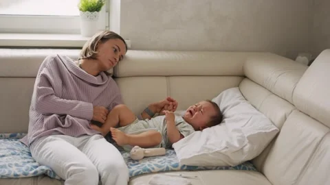 Mother measuring temperature of her ill kid at background. Sick child with high Stock Footage 161841817
