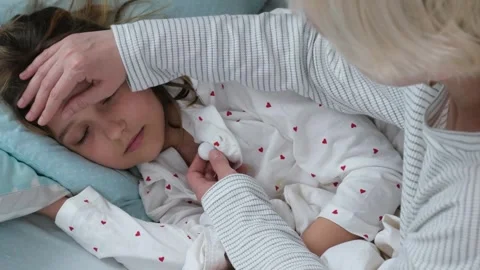 Mother measuring temperature of sick child with thermometer Stock Footage 331590885