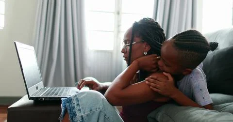Mother multi-tasking using computer laptop at home. Candid authentic and real Stock Photos