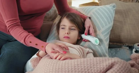 Mother parent checking temperature of he... | Stock Video | Pond5