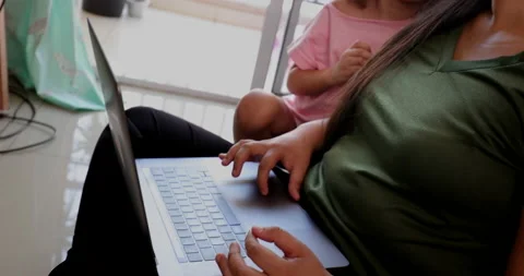 Mother parenting and working at the same time, mom multi-tasking between work Stock Footage 142527811