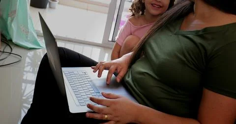 Mother parenting and working at the same time, mom multi-tasking between work 写真素材