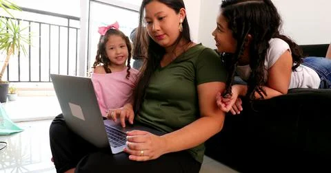 Mother parenting and working at the same time, mom multi-tasking between work Stock Photos