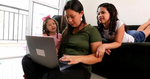 Mother parenting and working at the same time, mom multi-tasking between work Stock Photos