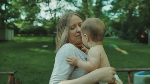 Mother playing and having fun with her little baby girl, spring park. Happy mom Stock-Footage 123301398