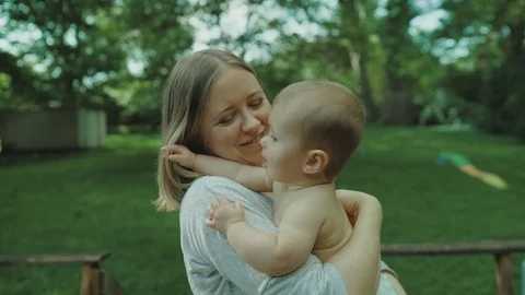 Mother playing and having fun with her little baby girl, spring park. Happy mom Stock-Footage 123304966
