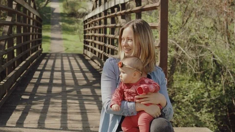 Mother playing and having fun with her little baby girl, spring park. Happy mom Stock-Footage 123443432