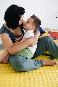Mother playing with cute disabled child, cerebral palsy Stock Photos