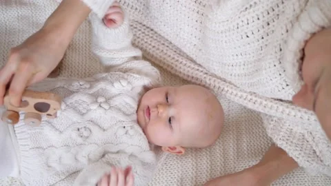 Mother Playing With Her Baby Using Wooden Eco Toy Wearing Knitted Sweaters At Stockbeeldmateriaal 138461795